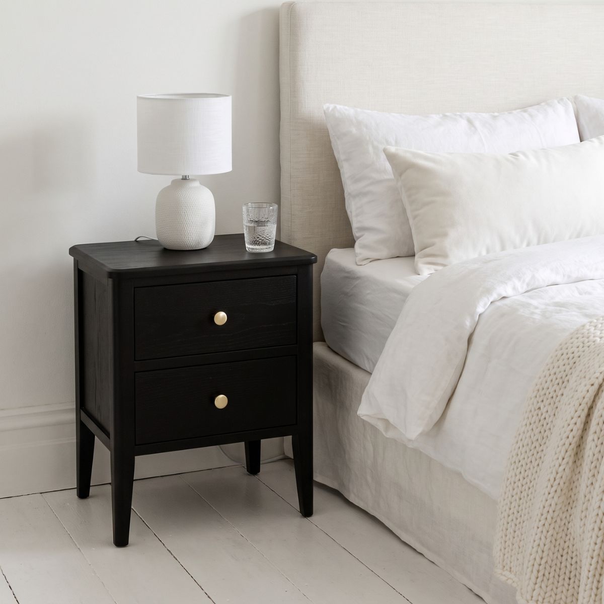 Alvar Black Two Drawer Bedside Table with gold handles and raised base