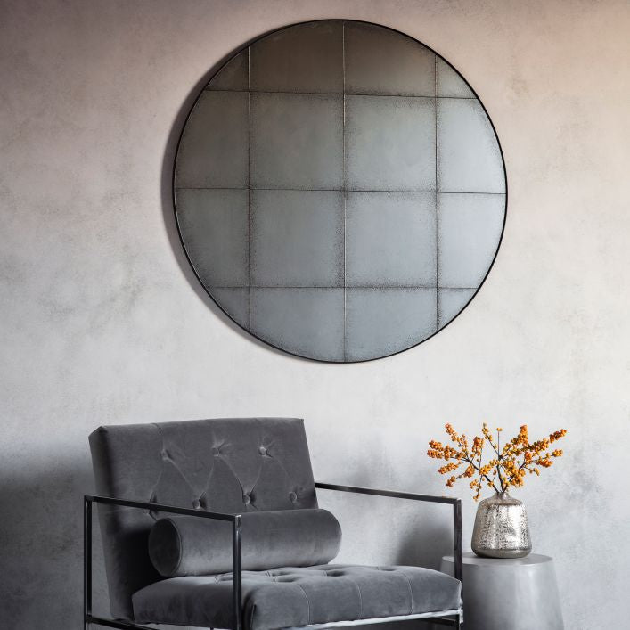 Baxter medium antiqued round wall mirror with grid detail in a structural metal outer frame | malletandplane.com