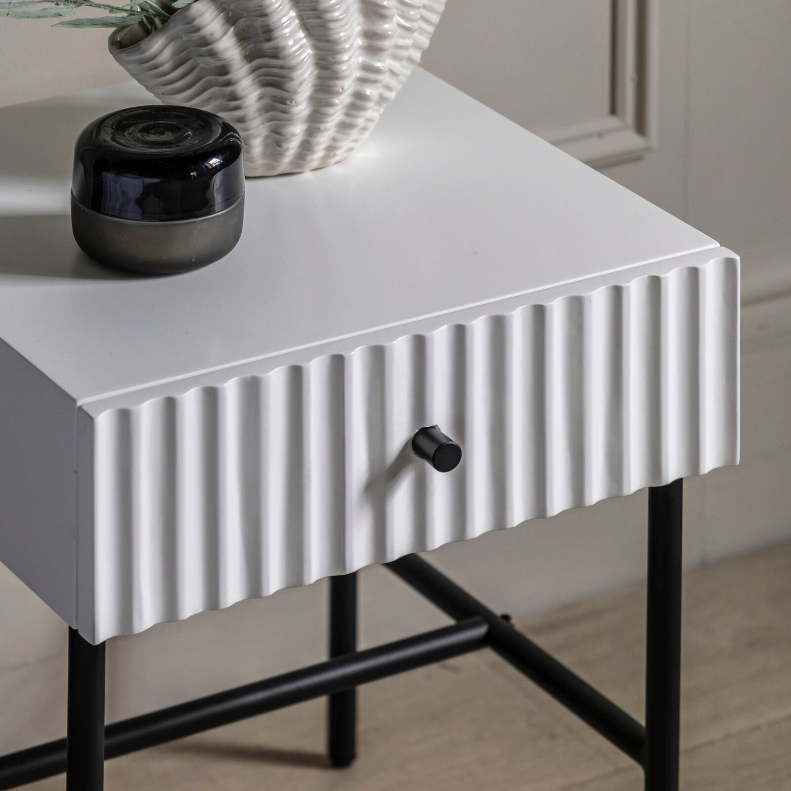 Flute bedside table with drawer in white finish with scalloped fascia and black metal underframe | malletandplane.com