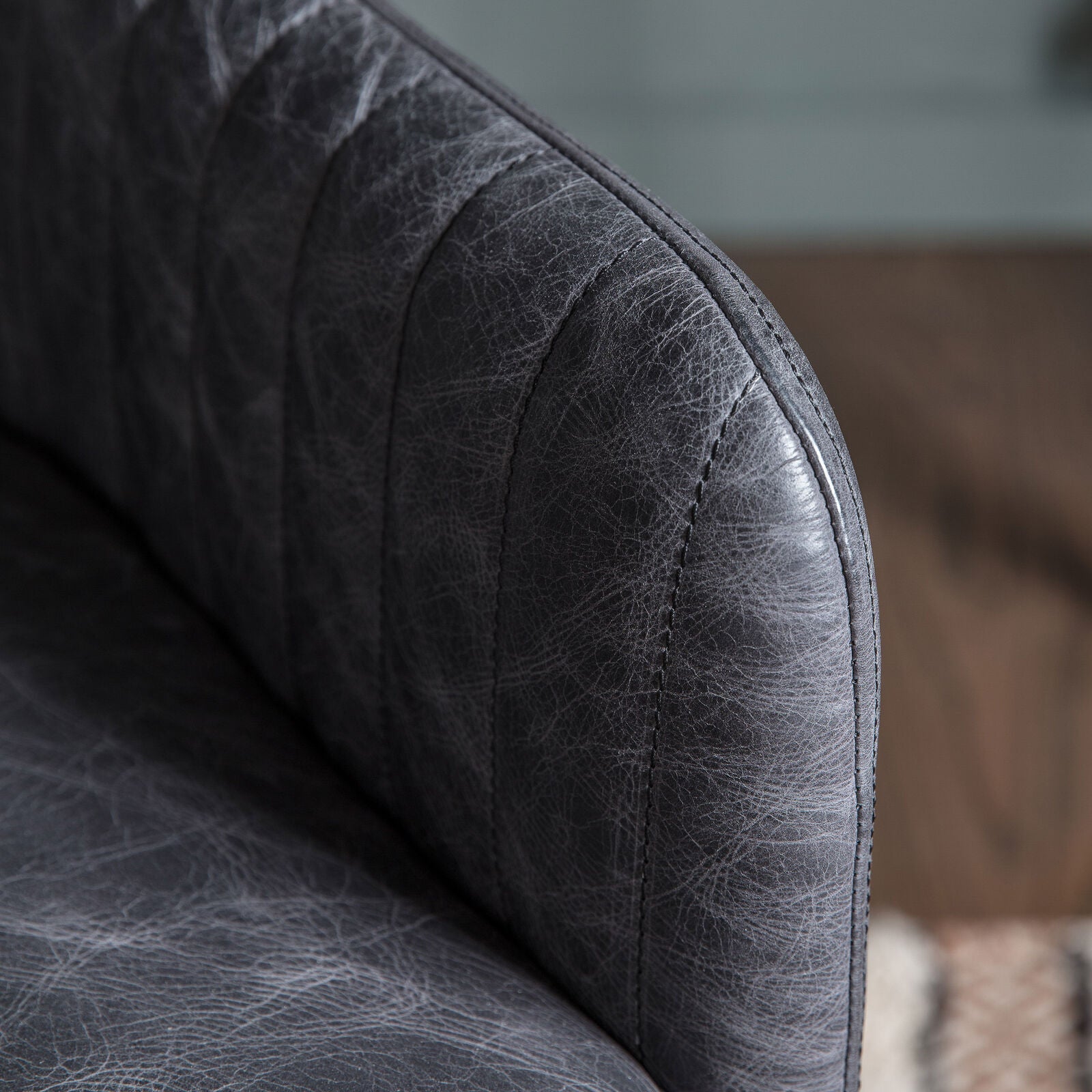 Ray leather upholstered padded swivel chair in antique ebony leather hide | malletandplane.com