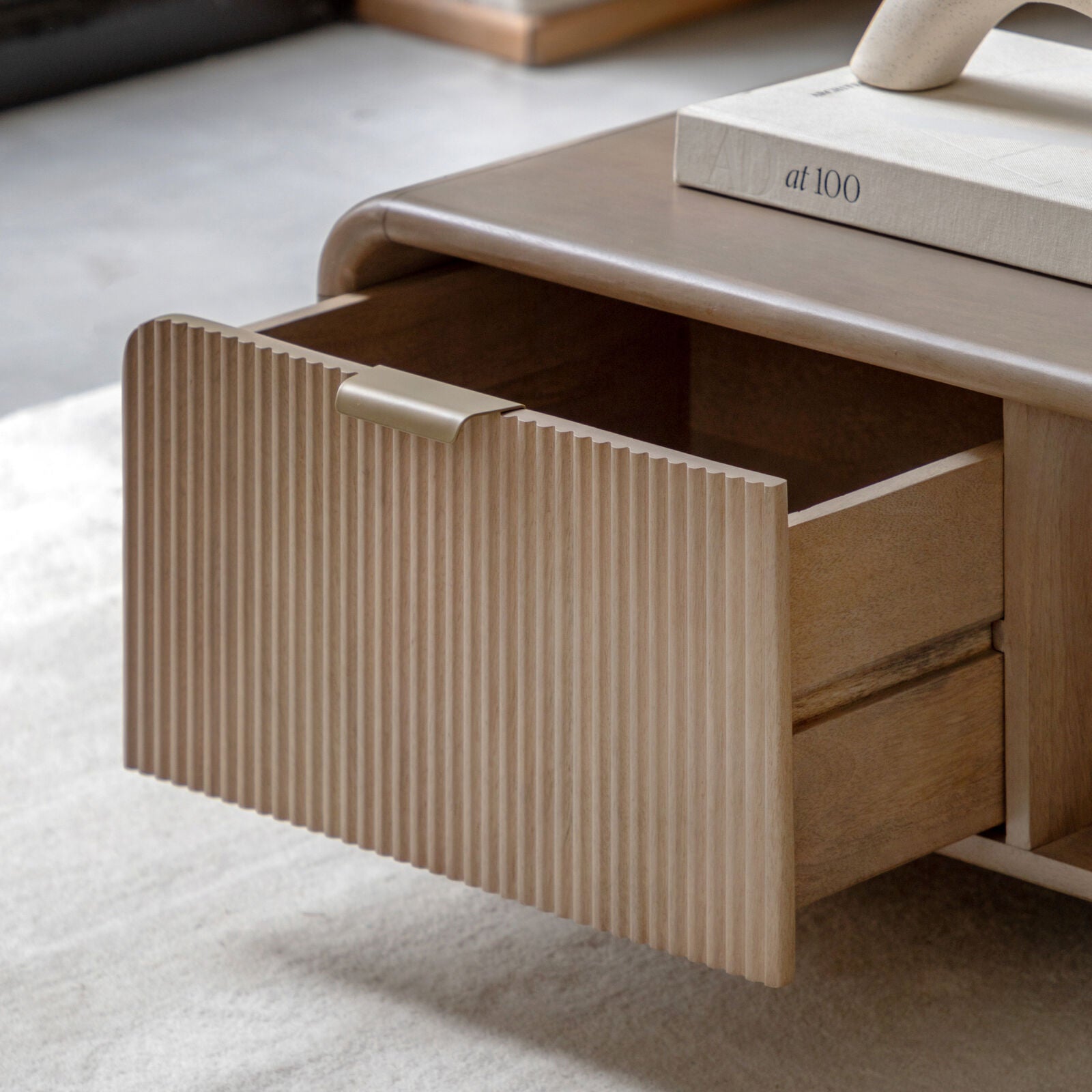 Rocca mango coffee table with curved edges, fluted drawer front and brushed brass hardware | malletandplane.com