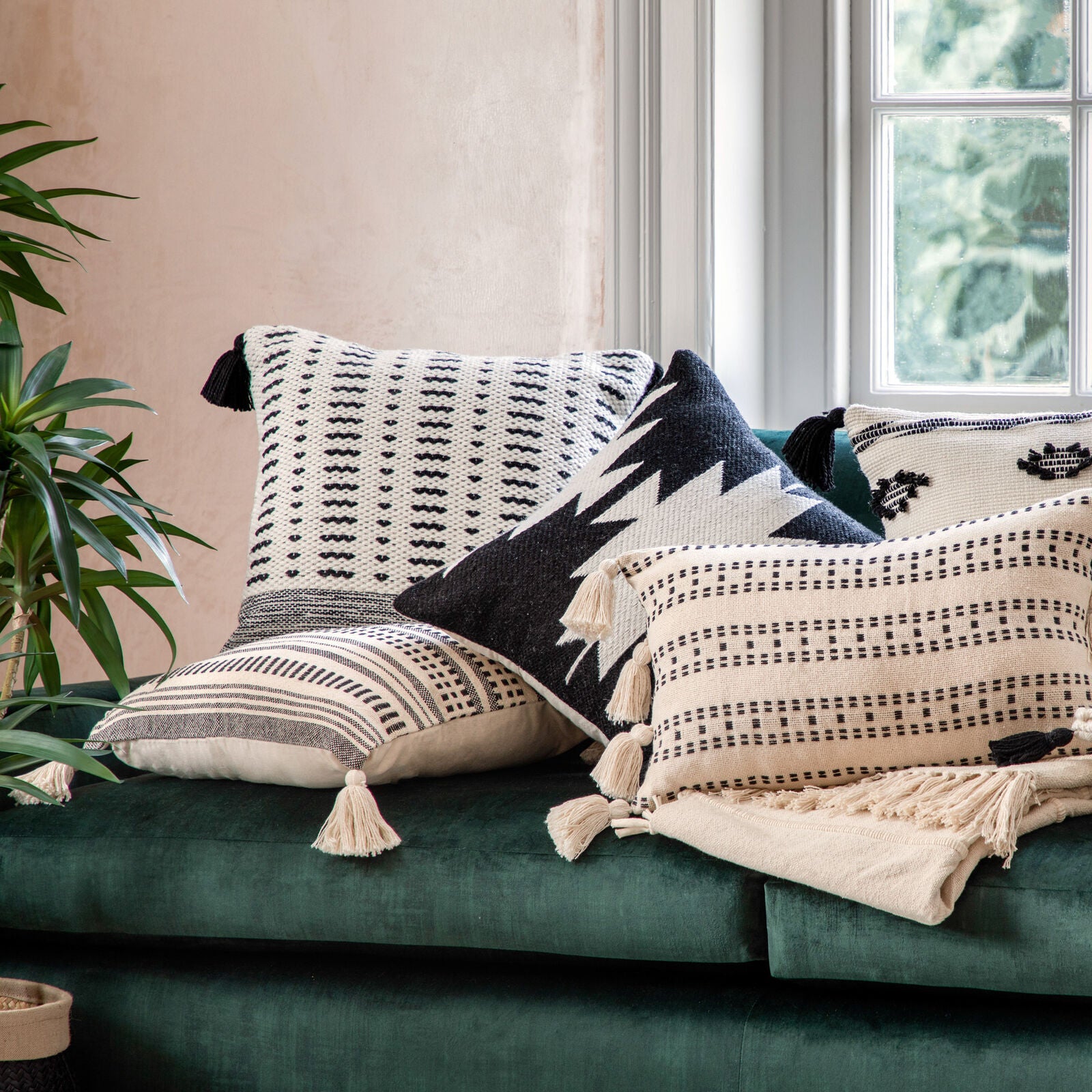 Sherpa square cushion with geometric design and tassels